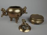 three pieces of brass are sitting next to each other on a table