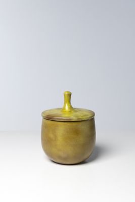 small yellow ceramic pot with lid on white surface