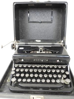 an old typewriter sitting in a case on a white surface