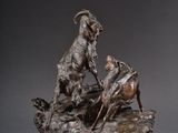 sculpture en bronze représentant une chèvre et un bélier sur un rocher