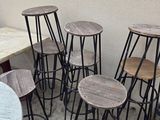 several stools and a table in a room with a white wall