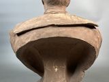 sculpture of a bust of a man with a hat on top of it