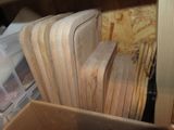 many pieces of wood stacked on top of each other in a box