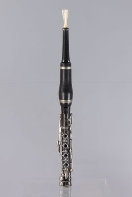 a close up of a clarinet on a gray background