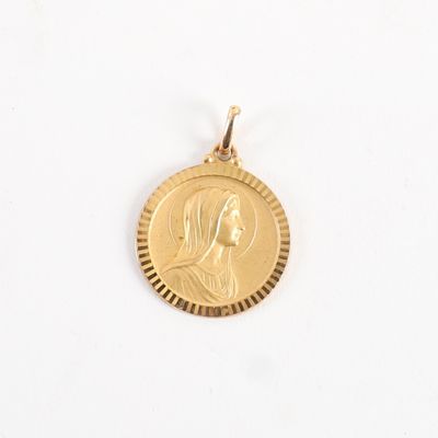 a close up of a gold coin with a woman ' s face on it