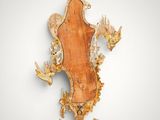 an image of a wall mounted mirror with a wooden frame and gold leaf decoration
