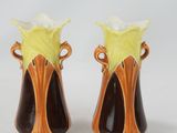 two vases that are sitting on a white surface