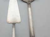 two spoons and a spatula on a white surface