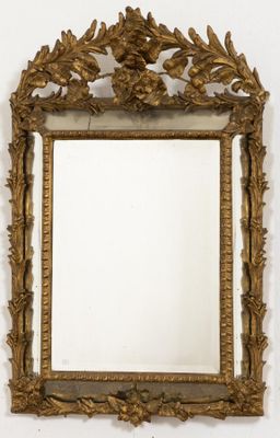 an image of a gold framed mirror hanging on a wall