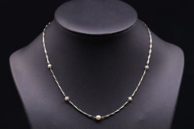a necklace with pearls on a mannequin mannequin