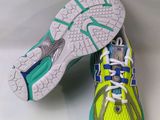 the soles of a pair of running shoes on a white surface