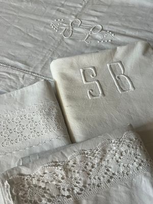a white table cloth with a monogram on it