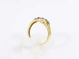 a close up of a gold ring with black and white diamonds