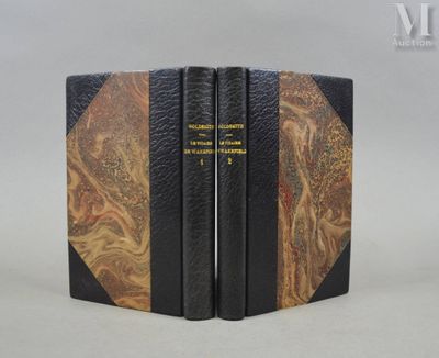 two books are stacked on top of each other on a table