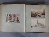 an open book with a picture of a church and other buildings