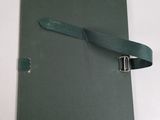 a green book with a leather strap on top of it