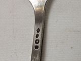 a fork that has a hole in the middle of it
