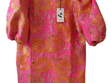an image of a pink and orange dress on a hanger