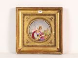 an old picture of a woman holding a book in a gold frame