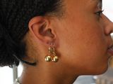 a woman that has a pair of earrings on her ear
