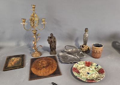 a table with various items on it including a candle, a plate, a plate of food, and a candle holder
