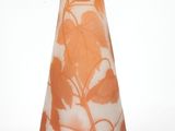 an orange vase with white flowers on it on a white background