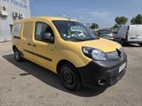 the small yellow van is parked in the parking lot