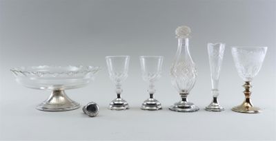 several glass and metal items are sitting on a white surface
