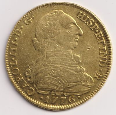 gros plan d'une pièce d'or sur une surface blanche