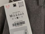 the label on the back of a pair of grey pants