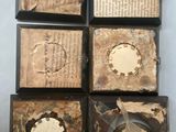 four pieces of old books are sitting on a white surface