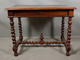 an old wooden table with a drawer on top of it