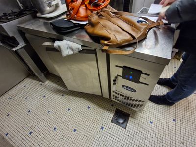 a person standing in a kitchen with a bag on the counter