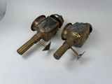 pair of antique brass lanterns on a white surface
