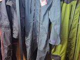 many different types of ski suits on display in a store