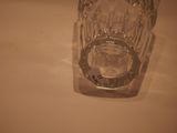 a clear glass with a small amount of water inside of it