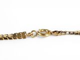 a close up of a gold chain on a white background