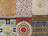 a close up of a quilt with many different designs on it