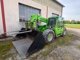 a green tractor parked in front of a building next to a building