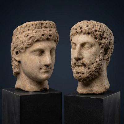 pair of marble heads of a man and a woman