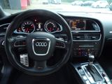 the interior of a car with a steering wheel and dashboard controls