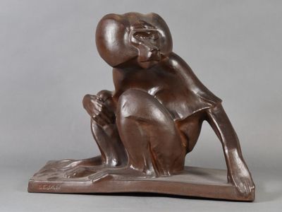 statue of a monkey sitting on top of a wooden base