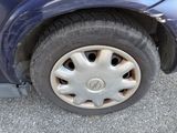a close up of a tire on a blue car