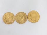 three gold coins, one of which is a sovereign and one of which is a sovereign