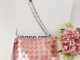 pink and white purse with pink flowers on a white table