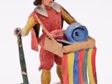 a figurine of a man holding a surfboard and a surfboard