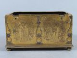 an old brass box with a design on the front