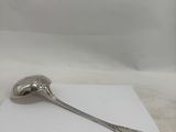 silver plated spoon sitting on top of a piece of paper on a table