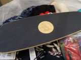 a skateboard that is laying on top of a pile of clothing