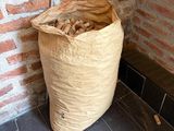 a bag of wood in front of a brick wall
